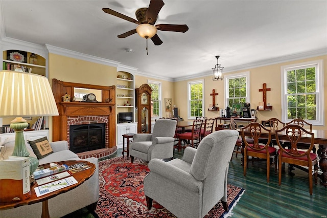 living room featuring plenty of natural light, ceiling fan, dark hardwood / wood-style floors, and a brick fireplace