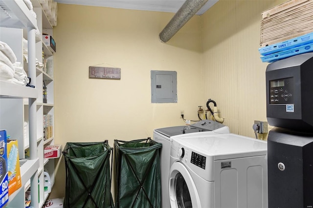 clothes washing area featuring electric panel, crown molding, and separate washer and dryer