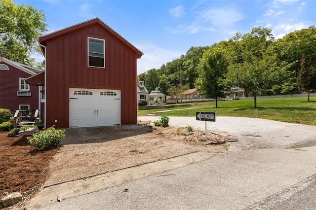 view of home's exterior with a yard and a garage