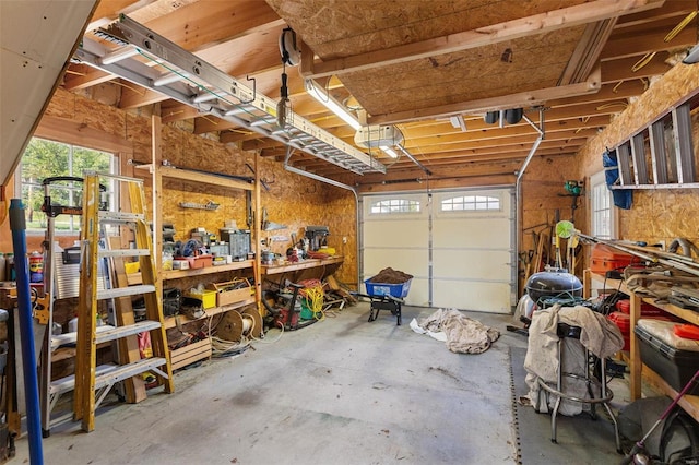 garage featuring a garage door opener and a workshop area