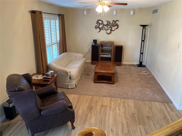 carpeted living room featuring ceiling fan