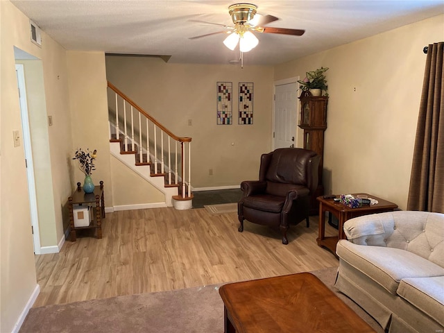 living room featuring ceiling fan and light carpet