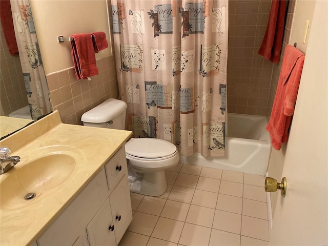 full bathroom featuring tile walls, tile floors, large vanity, toilet, and shower / bath combo with shower curtain