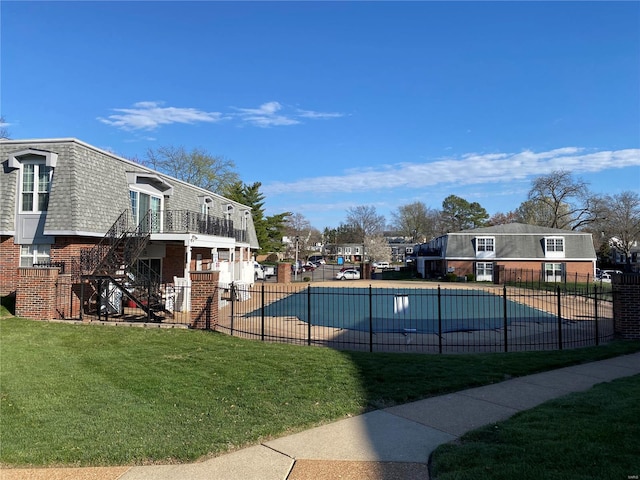 view of pool featuring a yard