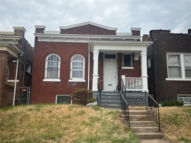 view of front of property with covered porch and a front yard