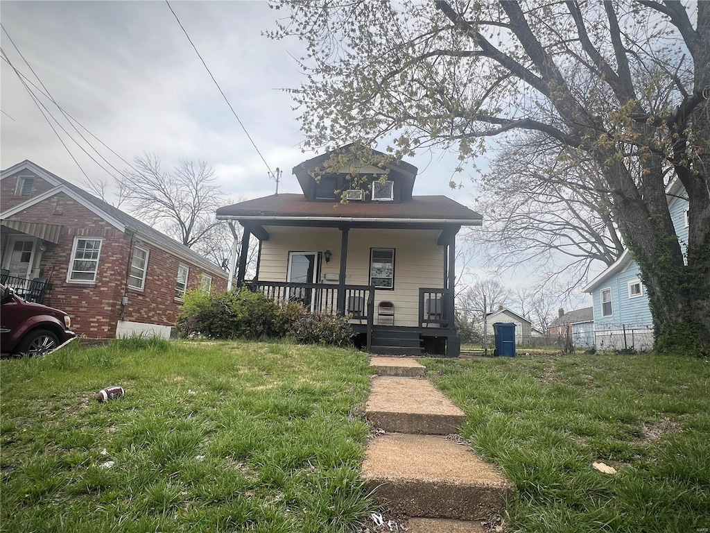 bungalow with a front lawn and a porch