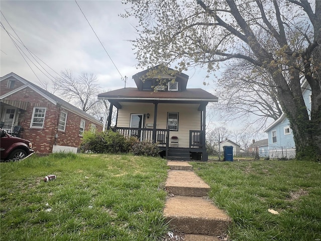 bungalow with a front lawn and a porch