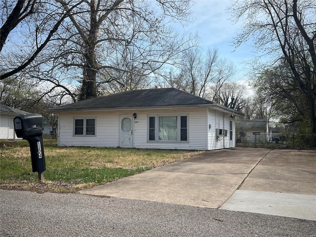 ranch-style home with a front lawn