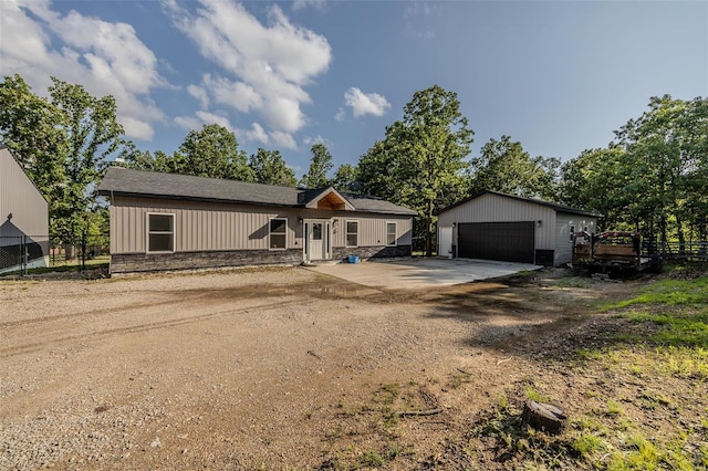 single story home featuring a garage and an outdoor structure