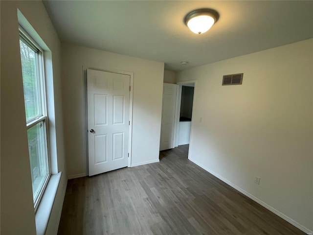 unfurnished bedroom featuring a closet and wood-type flooring