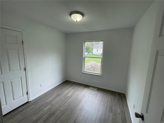 unfurnished room with hardwood / wood-style flooring