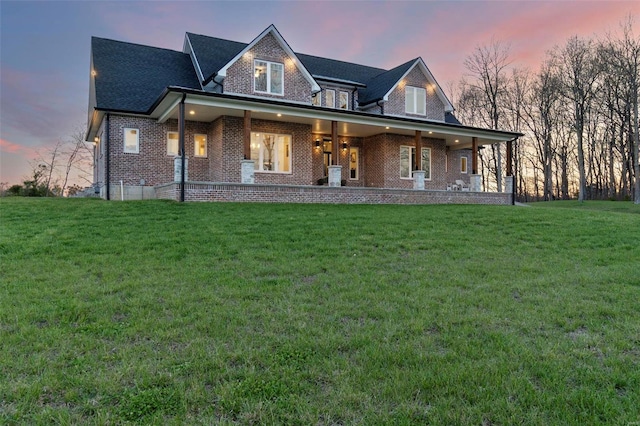 view of front of property with a lawn and a porch