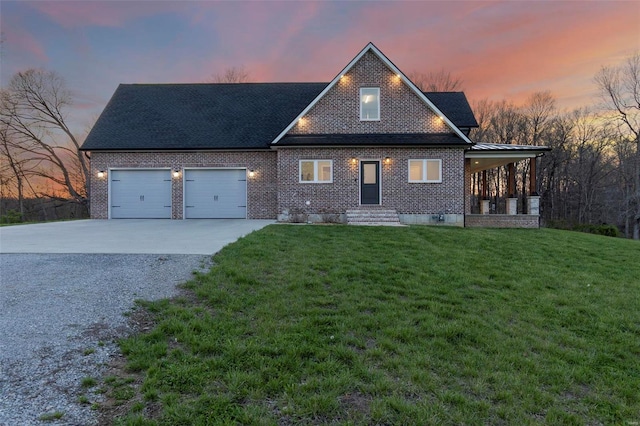 view of front of house featuring a yard and a garage