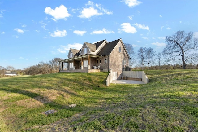 view of side of property featuring a patio area and a yard