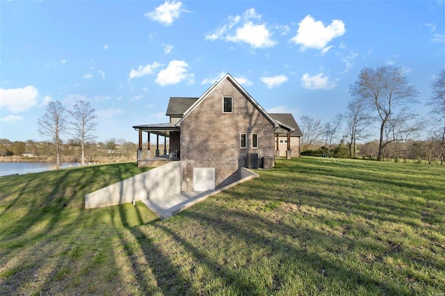 rear view of property with central AC, a yard, and a patio