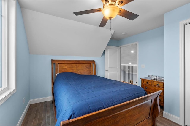 bedroom featuring vaulted ceiling, ceiling fan, and dark hardwood / wood-style floors