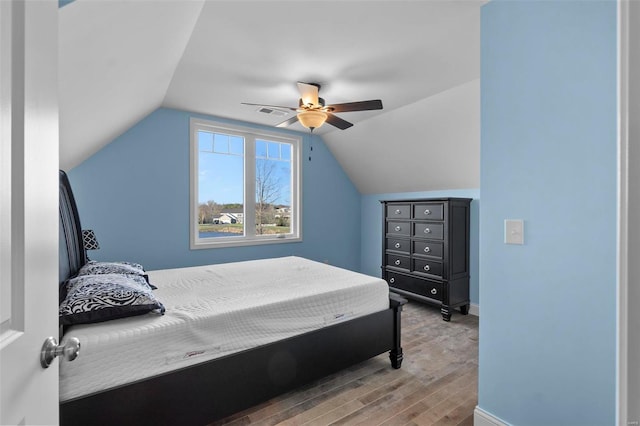 bedroom with lofted ceiling, ceiling fan, and hardwood / wood-style flooring