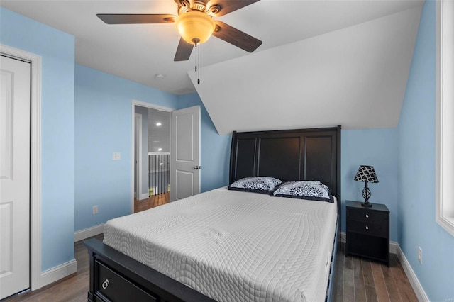 bedroom with dark hardwood / wood-style floors, ceiling fan, and lofted ceiling