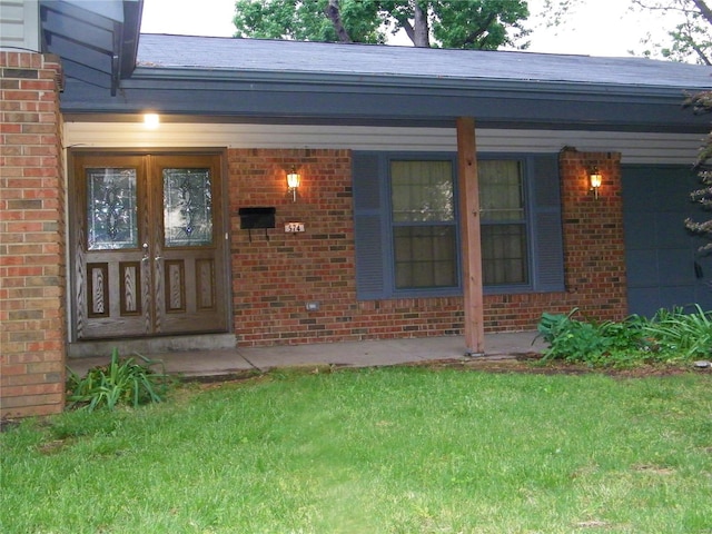 view of exterior entry with a lawn