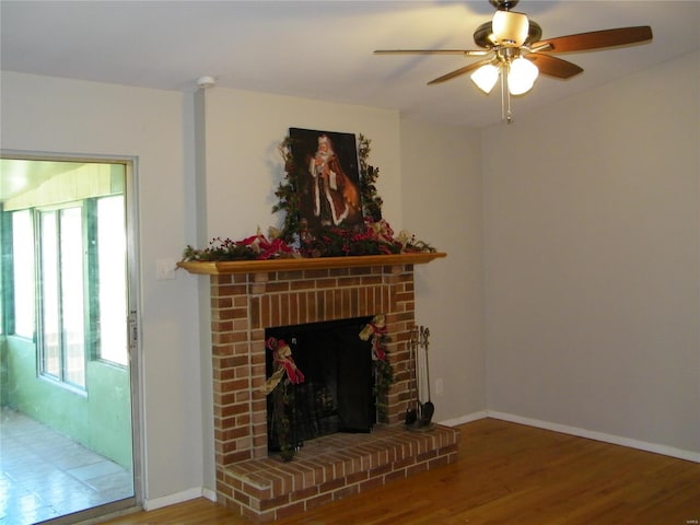 unfurnished living room featuring a fireplace, hardwood / wood-style floors, and ceiling fan