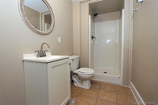 bathroom featuring vanity, toilet, a shower, and tile patterned flooring