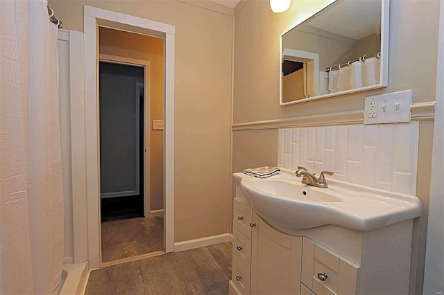 bathroom with vanity, walk in shower, and hardwood / wood-style floors