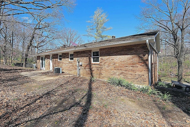 view of side of property with central air condition unit