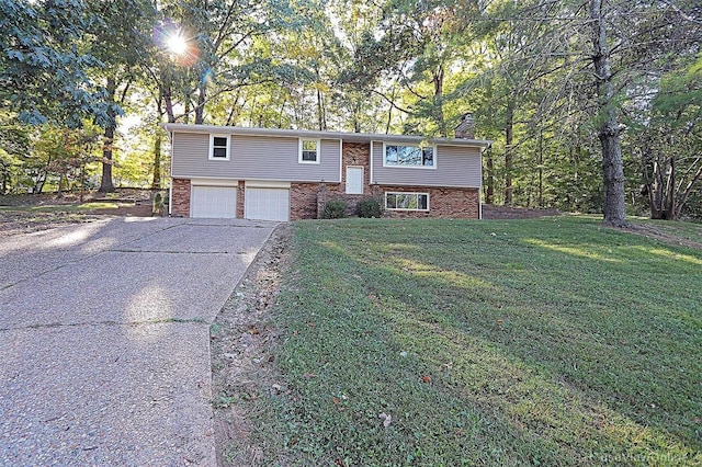 split foyer home with a front yard and a garage