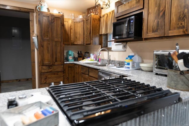 kitchen featuring black microwave, sink, and stainless steel dishwasher