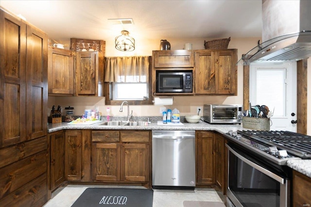 kitchen featuring stove, island range hood, sink, stainless steel dishwasher, and black microwave