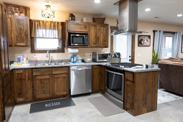 kitchen with sink, appliances with stainless steel finishes, island range hood, and plenty of natural light