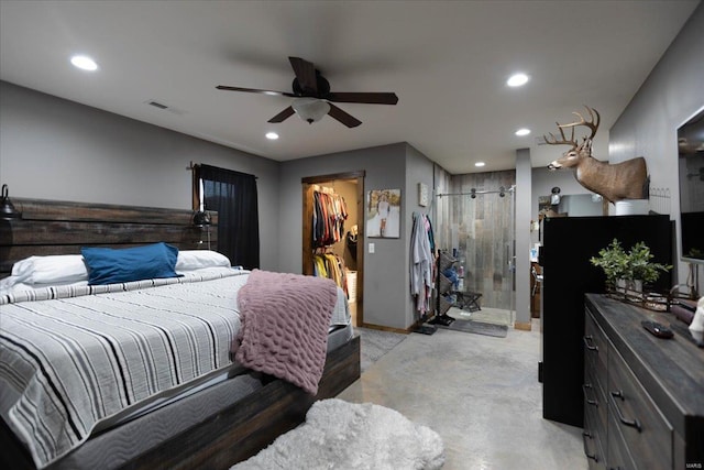 bedroom with a walk in closet, ceiling fan, and ensuite bathroom