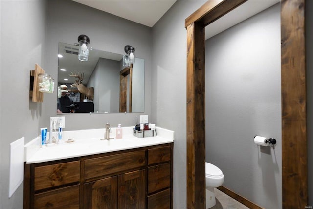 bathroom featuring vanity and toilet