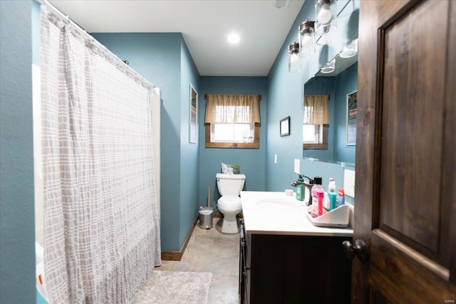 bathroom with toilet, tile floors, and vanity