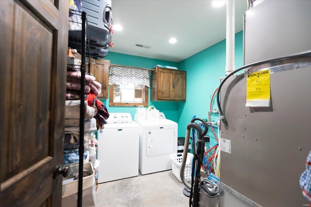 laundry area with cabinets and separate washer and dryer