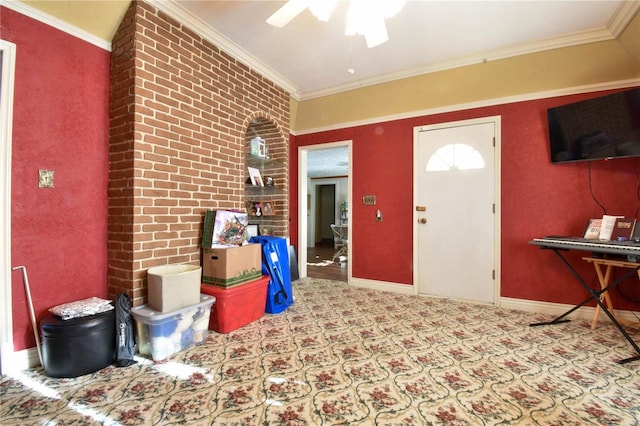 foyer with light colored carpet, ceiling fan, brick wall, and ornamental molding