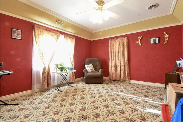 living area with ceiling fan, light carpet, and ornamental molding