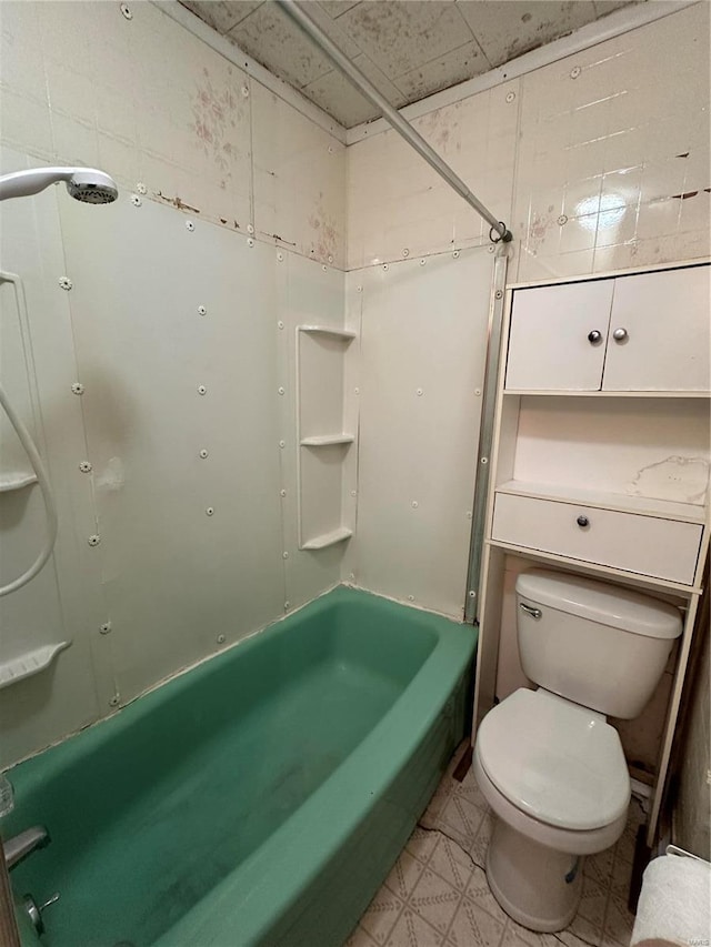 bathroom featuring shower / washtub combination, toilet, and tile flooring