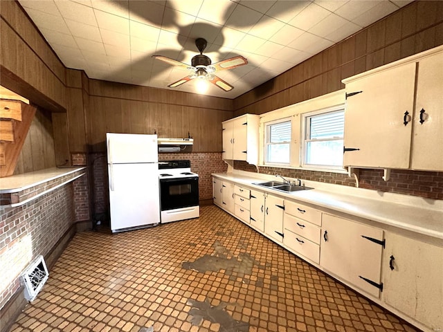 kitchen with ceiling fan, white appliances, white cabinetry, dark tile flooring, and sink