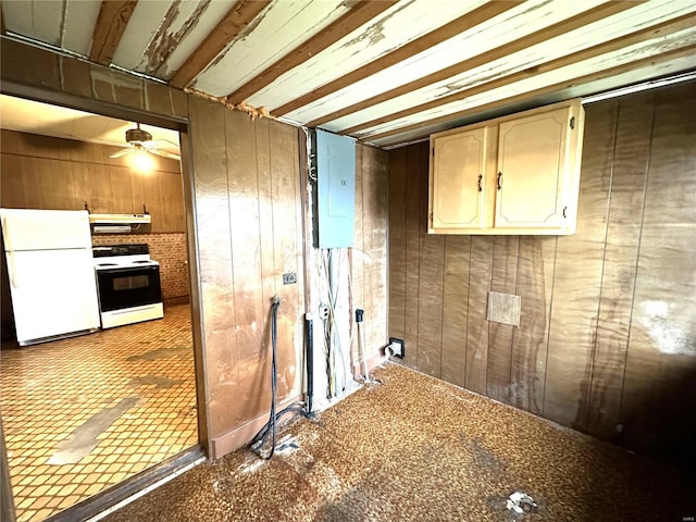 kitchen featuring white appliances, wood walls, and ceiling fan