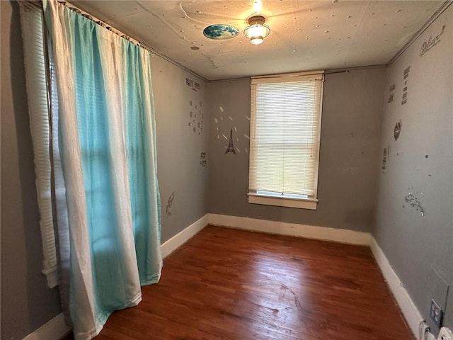 empty room with dark wood-type flooring