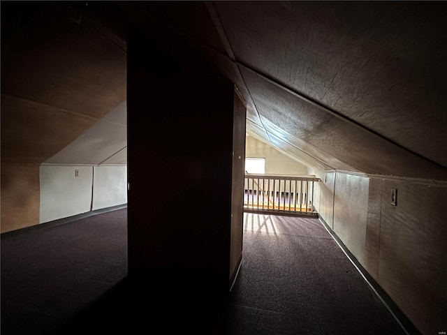 bonus room featuring lofted ceiling and carpet