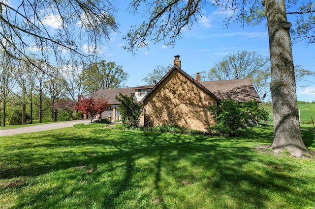 view of side of home featuring a yard