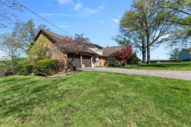 view of front of house featuring a garage and a front lawn