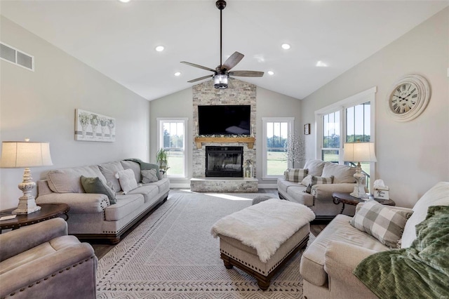 living room featuring a fireplace, high vaulted ceiling, and ceiling fan