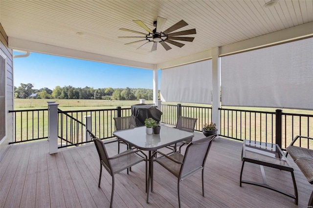 wooden terrace with a grill and ceiling fan