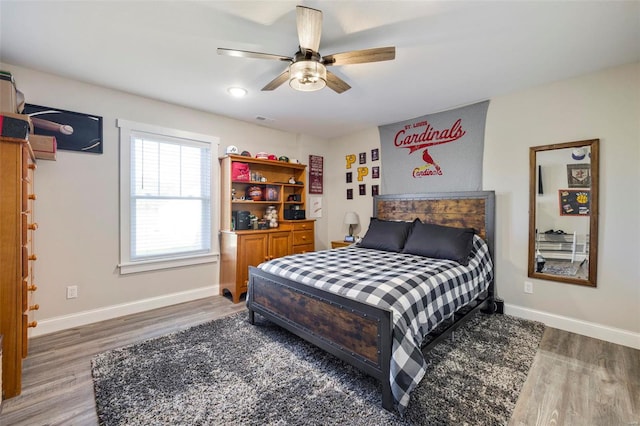 bedroom featuring ceiling fan and dark wood-type flooring