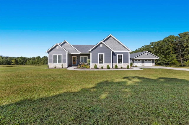 view of front of house with a front yard and a garage