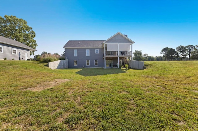 back of house with a lawn