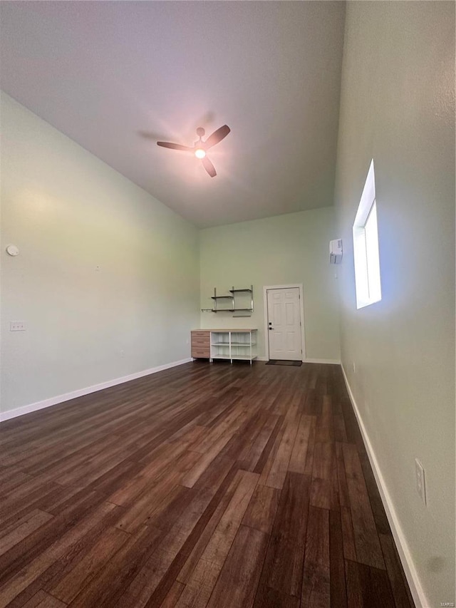 unfurnished living room with dark hardwood / wood-style floors and ceiling fan